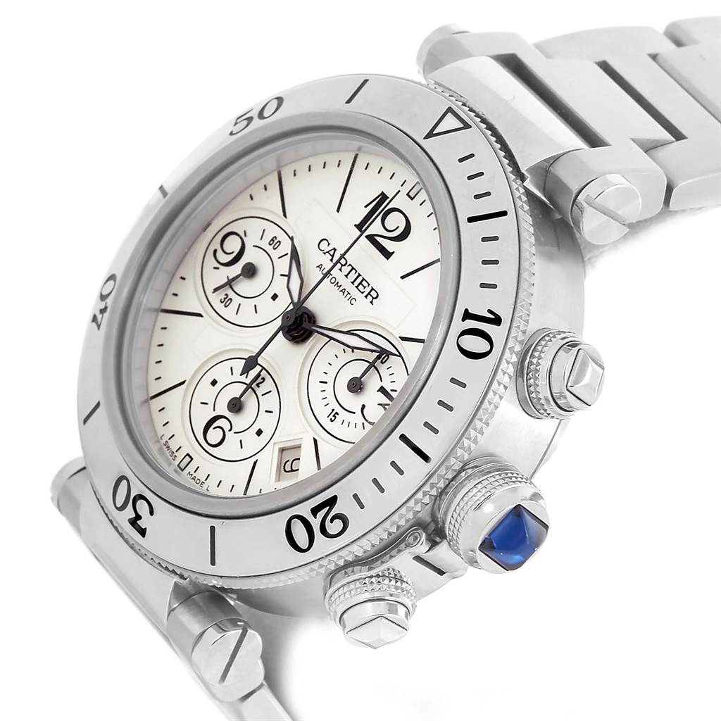 The image shows a close-up angle of a Cartier Pasha W31089M7 Men
s Stainless Steel Silver Dial W31089M7 Men
s Stainless Steel Silver Dial watch, highlighting the face, bezel, and crown with a blue gemstone.
