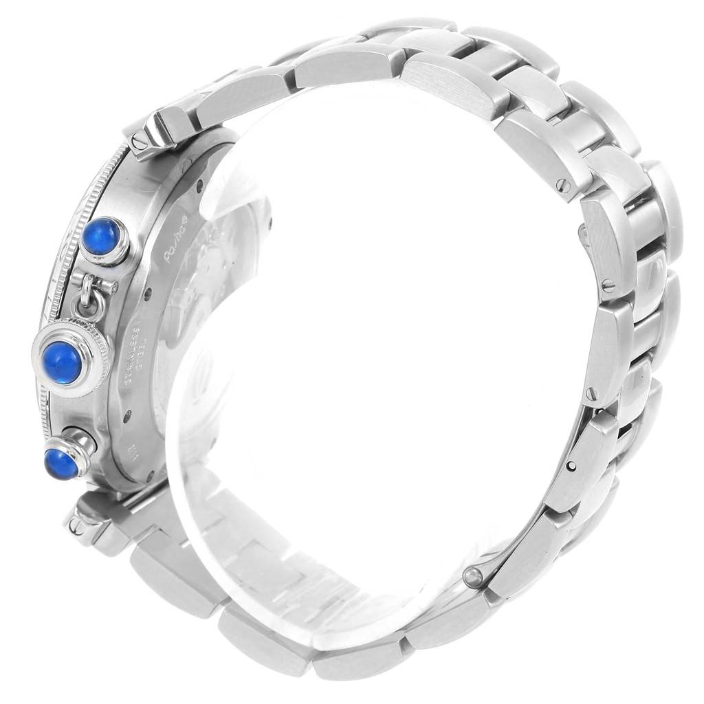 The image shows a side view of a Cartier Pasha W31030H3 Men
s Stainless Steel Silver Dial W31030H3 Men
s Stainless Steel Silver Dial watch, highlighting its stainless steel bracelet and crown protection system with blue cabochons.