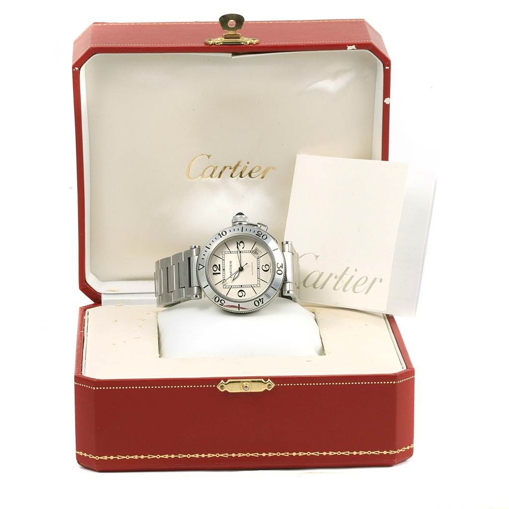 The Cartier Pasha W31080M7 Men
s Stainless Steel Silver Dial W31080M7 Men
s Stainless Steel Silver Dial watch is presented in its open red box, showcasing the watch face, bracelet, and accompanying documents.