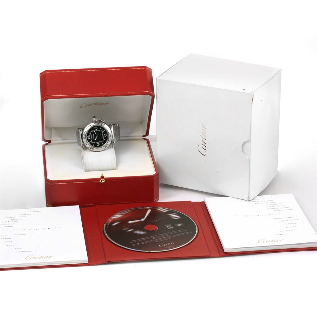 The Cartier Pasha W31077M7 Men's Stainless Steel Black Dial W31077M7 Men's Stainless Steel Black Dial watch is displayed in its box, accompanied by the packaging, manual, and a CD, viewed from the front.