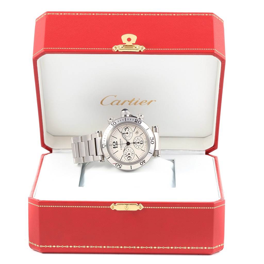 The Cartier Pasha W31089M7 Men's Stainless Steel Silver Dial W31089M7 Men's Stainless Steel Silver Dial watch is shown in an open red display box, featuring its dial, bracelet, and chronograph subdials.