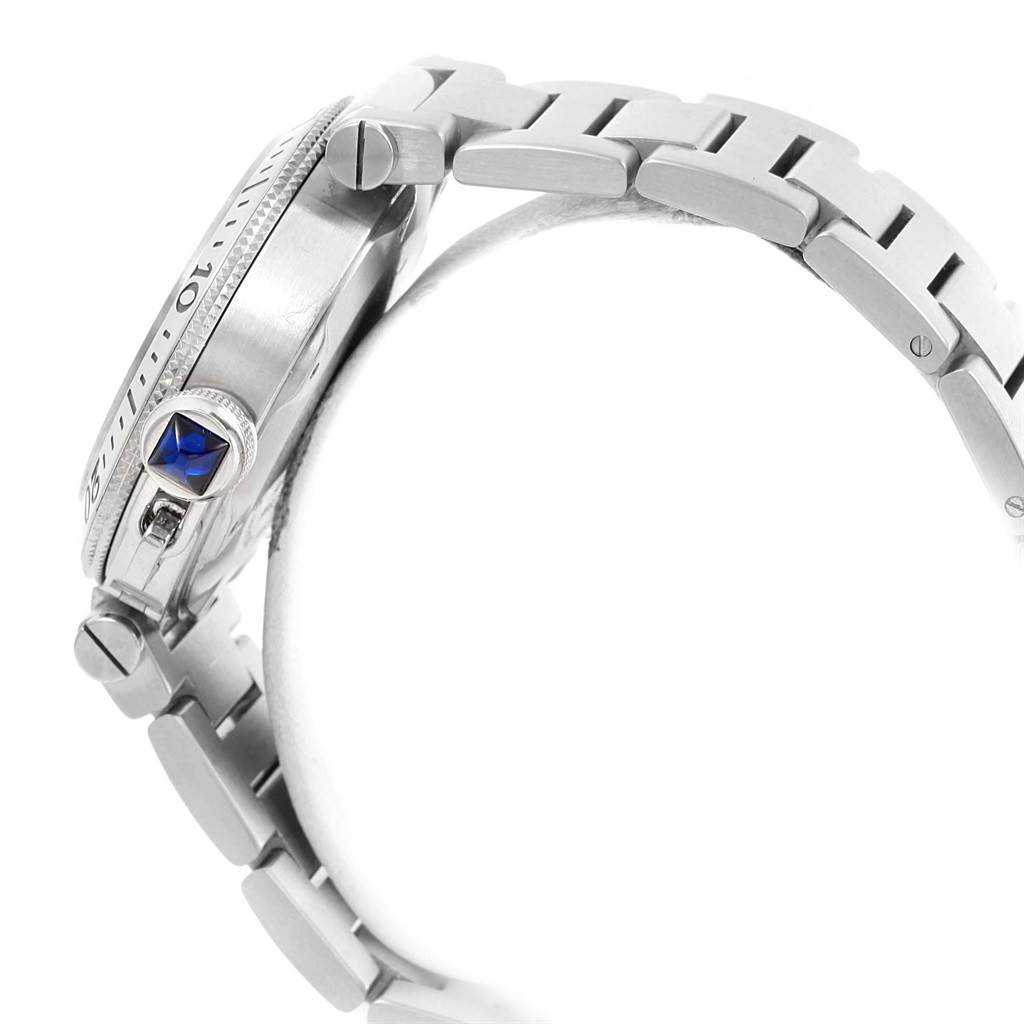 The image shows a side profile of the Cartier Pasha W31080M7 Men
s Stainless Steel Silver Dial W31080M7 Men
s Stainless Steel Silver Dial watch, highlighting its crown with a blue gem and part of the metal bracelet.
