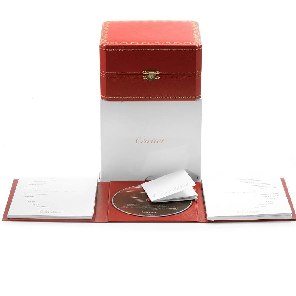 The image shows the packaging and accessories for a Cartier Pasha W31080M7 Men
s Stainless Steel Silver Dial W31080M7 Men
s Stainless Steel Silver Dial watch, including a red box, white booklet, and a CD.