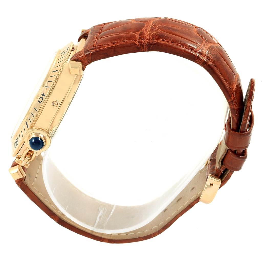 This image shows a side view of a Cartier Pasha W30144D1 Men's Yellow Gold Silver Dial W30144D1 Men's Yellow Gold Silver Dial watch featuring a gold case and brown leather strap.