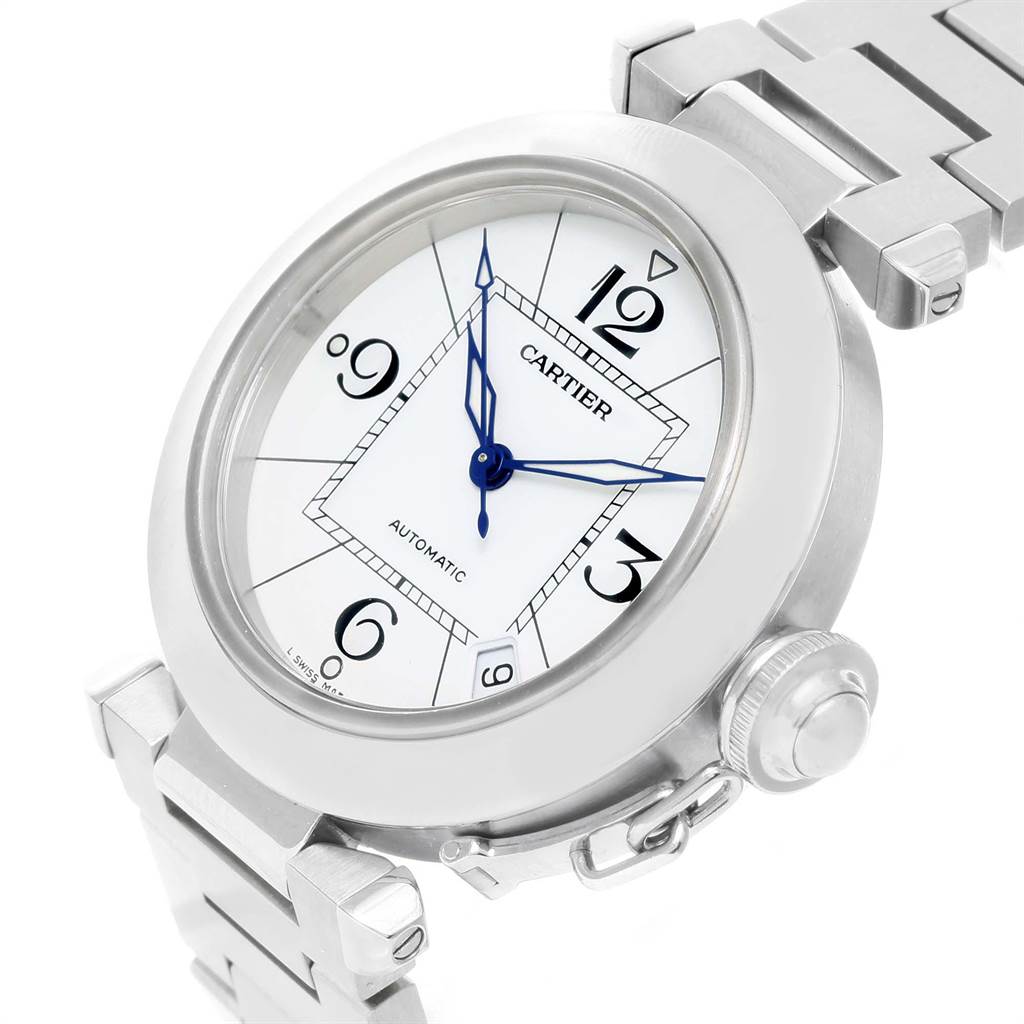 The image shows a Cartier Pasha W31074M7 Stainless Steel White Dial W31074M7 Stainless Steel White Dial watch at an angled close-up, highlighting its face, blue hands, crown, and part of the metallic strap.