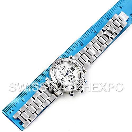 The image shows a Cartier Pasha W31030H3 Women
s Stainless Steel Silver Dial W31030H3 Women
s Stainless Steel Silver Dial watch laid flat against a blue ruler, displaying its face and metal bracelet.