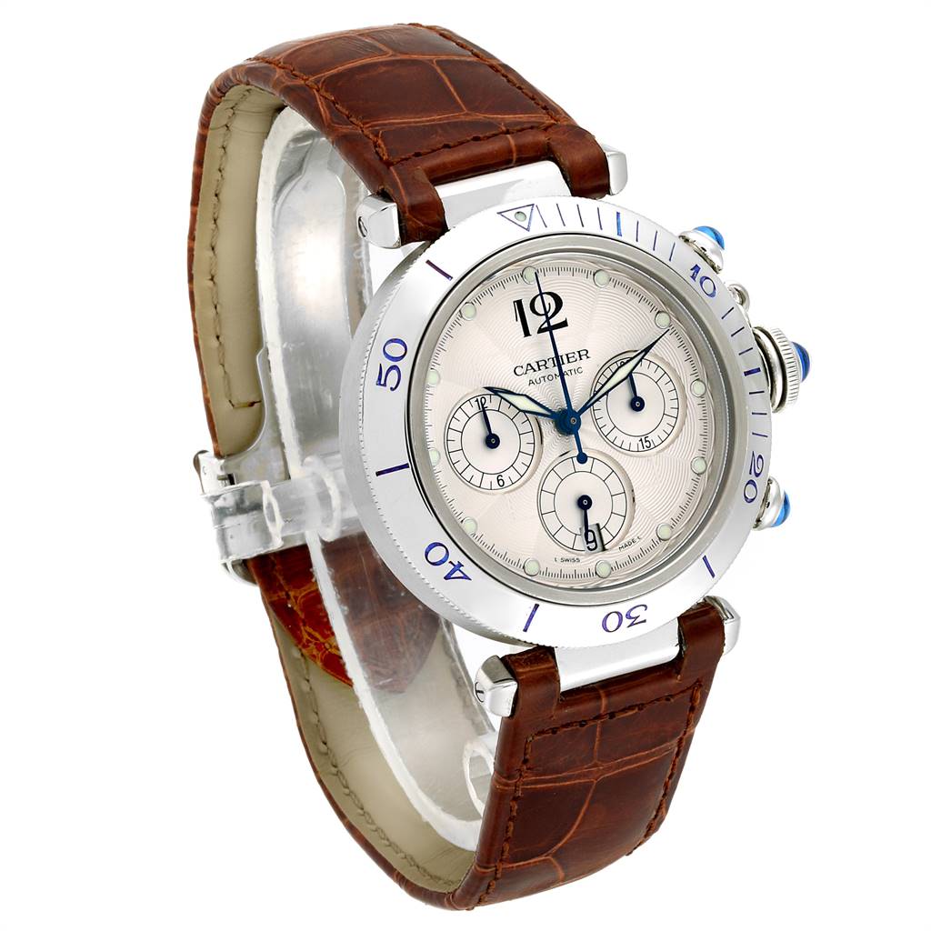 The image shows a Cartier Pasha W3103055 Men
s Stainless Steel Silver Dial W3103055 Men
s Stainless Steel Silver Dial watch at an angle displaying its face, bezel, crown, subdials, and leather strap.