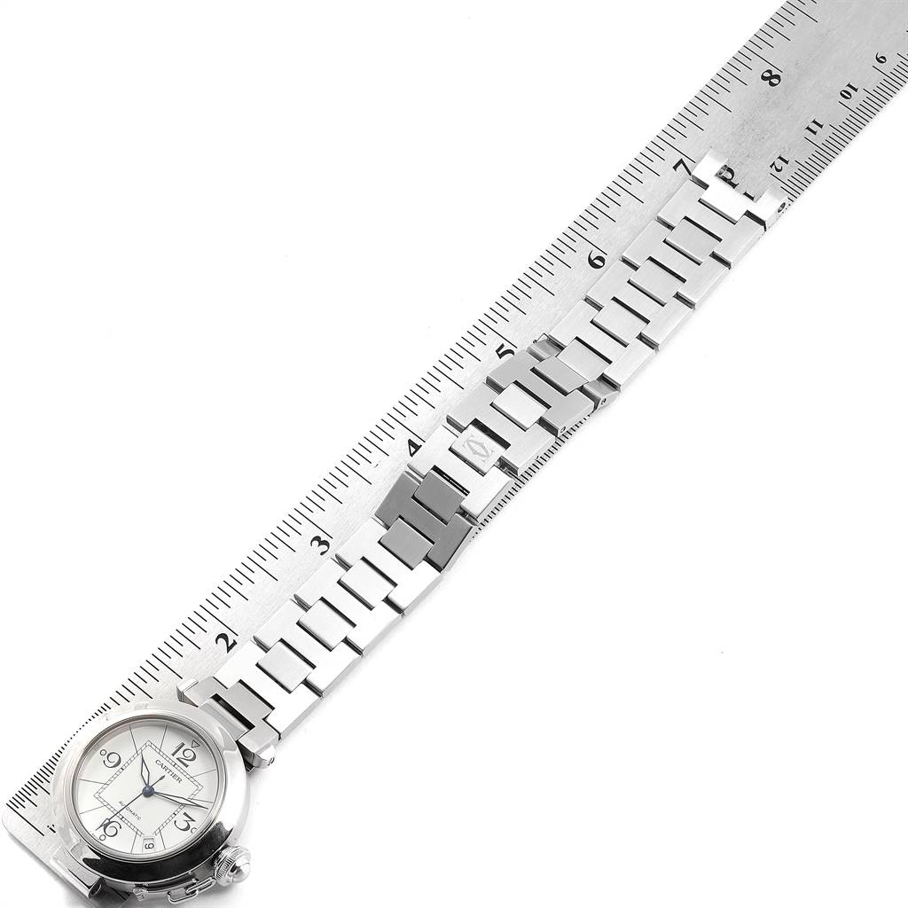 This image shows the face and bracelet of a Cartier Pasha W31074M7 Stainless Steel White Dial W31074M7 Stainless Steel White Dial watch, measured with a ruler.