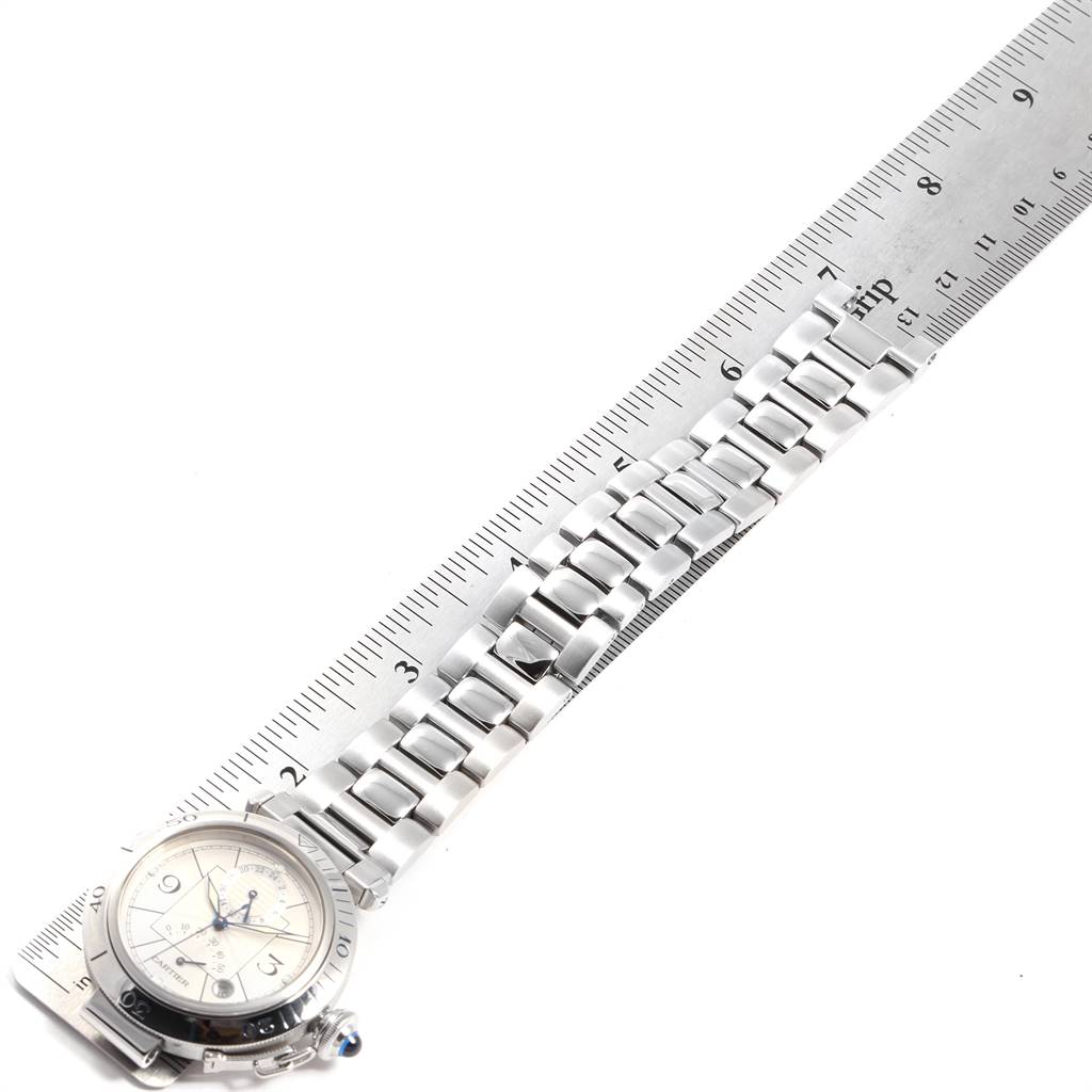 The image shows the Cartier Pasha W31037H3 Men's Stainless Steel Silver Dial W31037H3 Men's Stainless Steel Silver Dial watch from an angled top view, with a focus on the face and bracelet aligned with a ruler.