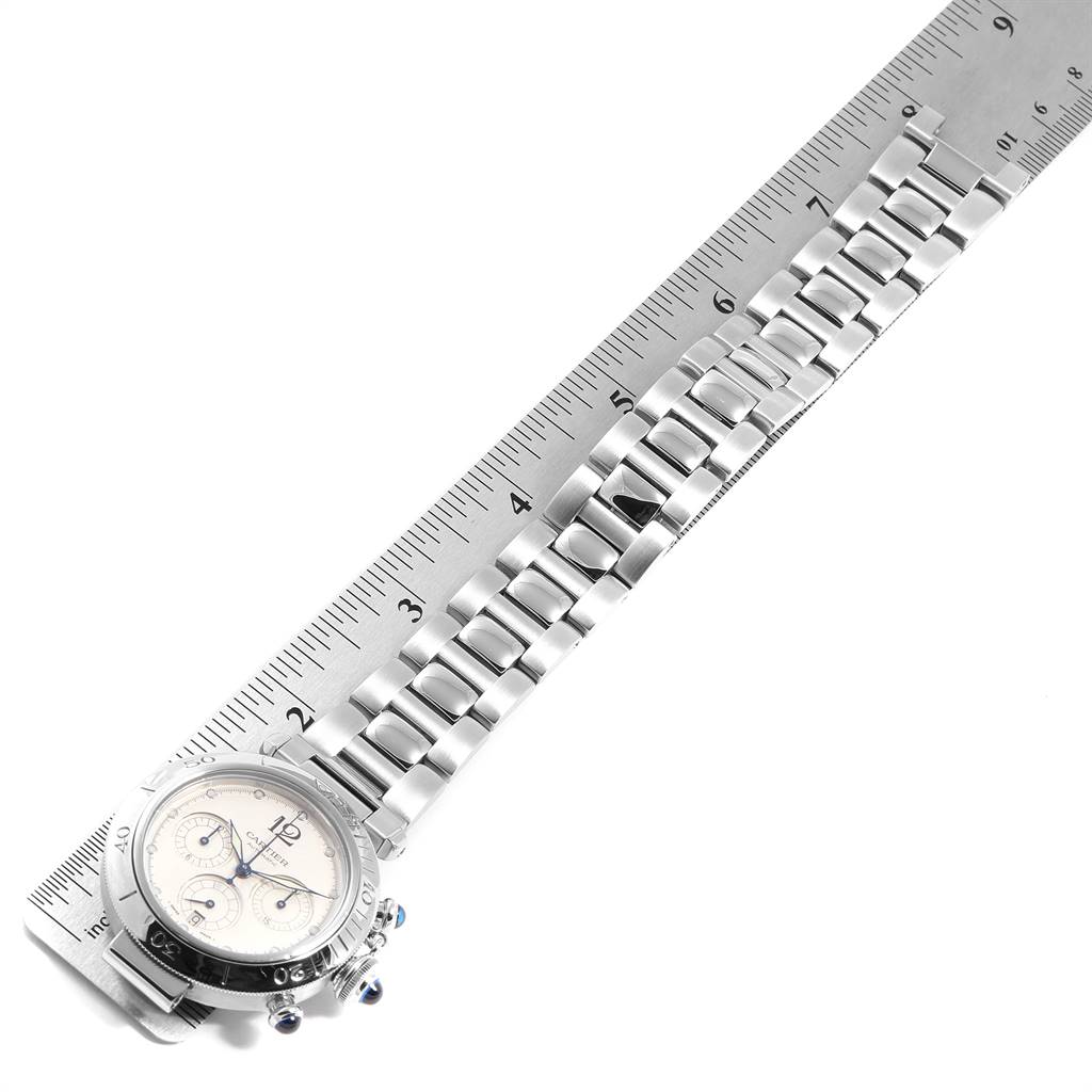 The image shows a Cartier Pasha W31030H3 Men
s Stainless Steel Silver Dial W31030H3 Men
s Stainless Steel Silver Dial model watch displayed flat, with a stainless steel bracelet alongside a ruler.