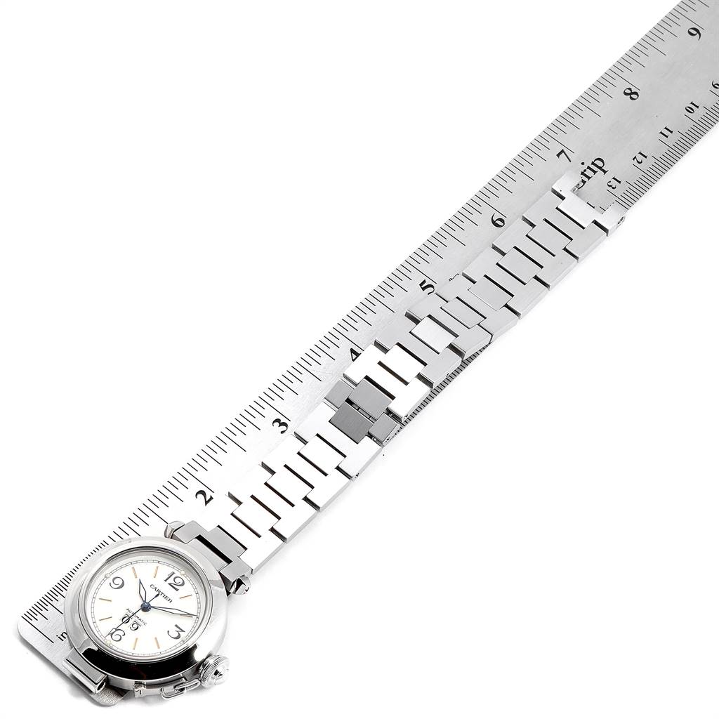 The image shows a Cartier Pasha W31044M7 Women's Stainless Steel White Dial W31044M7 Women's Stainless Steel White Dial watch placed alongside a ruler, focusing on the watch face and the metal bracelet.