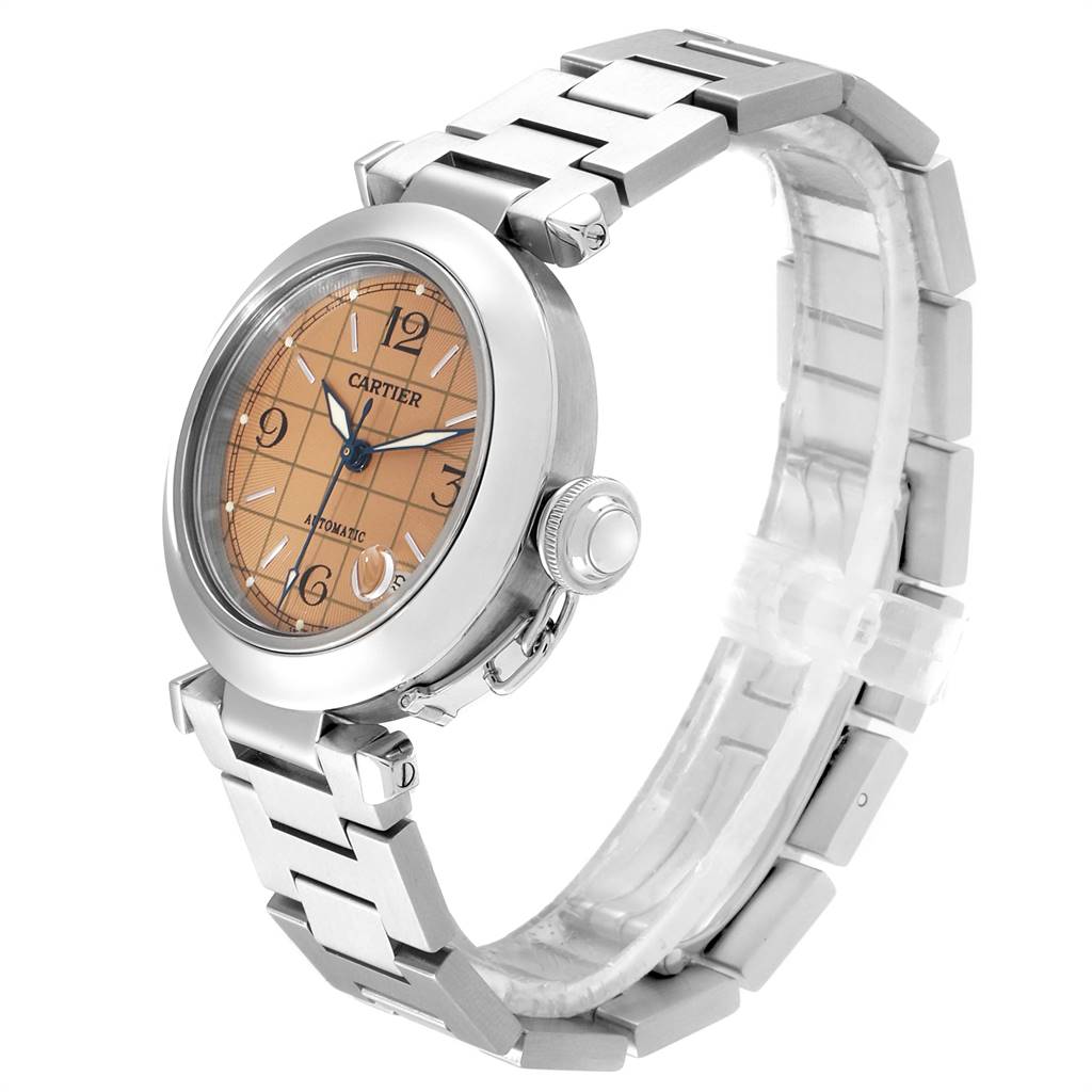 The image shows a side and angled view of a Cartier Pasha W31024M7 Men's Stainless Steel Pink Dial W31024M7 Men's Stainless Steel Pink Dial watch, highlighting its face, crown, and metal bracelet.