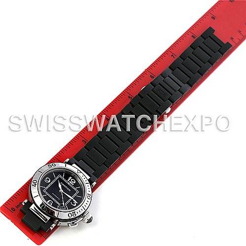The image shows a Cartier Pasha W31077U2 Men's Stainless Steel Black Dial W31077U2 Men's Stainless Steel Black Dial model watch laid flat next to a red ruler, displaying its dial and bracelet.