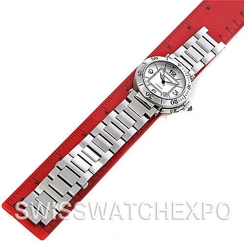 The Cartier Pasha W31080M7 Men
s Stainless Steel Silver Dial W31080M7 Men
s Stainless Steel Silver Dial watch is shown lying flat against a ruler, displaying its face and full metal bracelet.