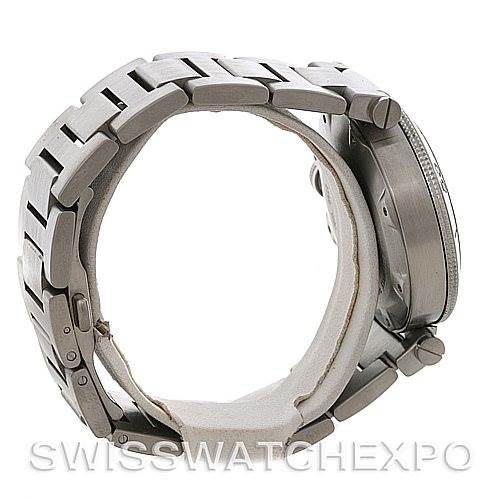 The image shows the side view of a Cartier Pasha W31077M7 Men
s Stainless Steel Black Dial W31077M7 Men
s Stainless Steel Black Dial watch, highlighting its metal bracelet and crown guards.