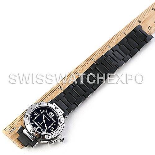 The image shows the Cartier Pasha W31077U2 Men's Stainless Steel Black Dial W31077U2 Men's Stainless Steel Black Dial watch from a top-down angle, with focus on its face and full black strap, alongside a ruler for scale.
