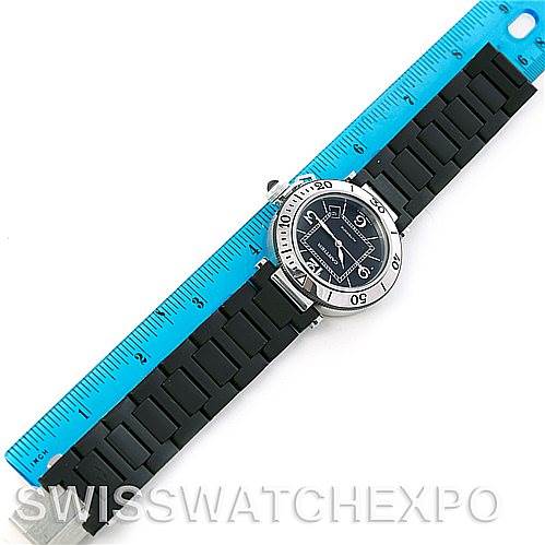 The Cartier Pasha W31077U2 Men
s Stainless Steel Black Dial W31077U2 Men
s Stainless Steel Black Dial model watch is shown from a top-down angle, highlighting the face, bezel, and rubber strap alongside a ruler.