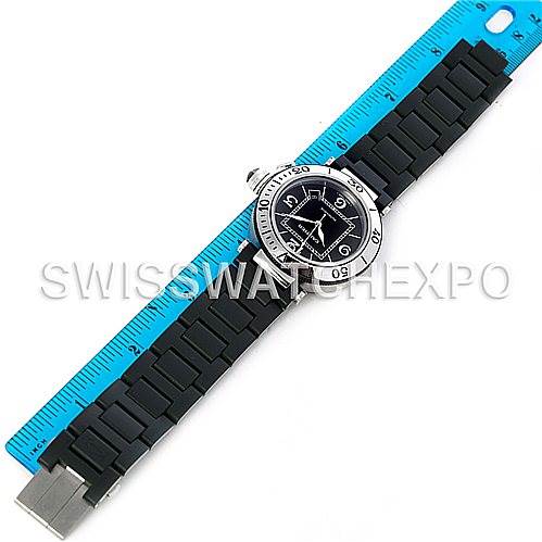 The image shows a top view of a Cartier Pasha W31077U2 Men's Stainless Steel Black Dial W31077U2 Men's Stainless Steel Black Dial watch with a black strap and a blue ruler alongside it.