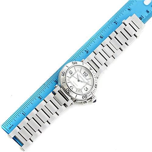The image shows an overhead view of a Cartier Pasha W31080M7 Men
s Stainless Steel Silver Dial W31080M7 Men
s Stainless Steel Silver Dial watch alongside a ruler, displaying both the face and metal bracelet.