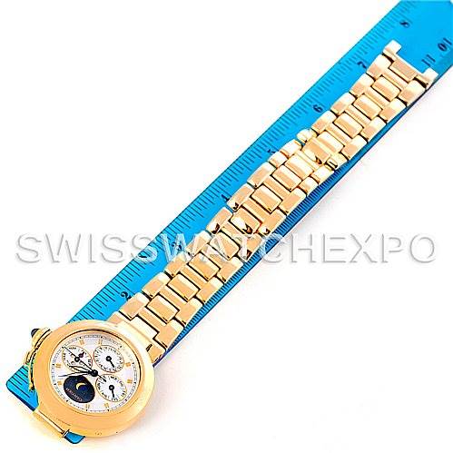 The image shows an overhead view of a Cartier Pasha MG222080 Men's Yellow Gold Silver Dial MG222080 Men's Yellow Gold Silver Dial model watch, displaying its face and gold bracelet against a ruler for scale.