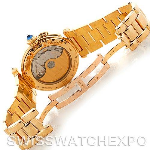 This image shows the back of a Cartier Pasha MG222080 Men's Yellow Gold Silver Dial MG222080 Men's Yellow Gold Silver Dial watch, revealing the movement mechanism and part of its gold bracelet and clasp.