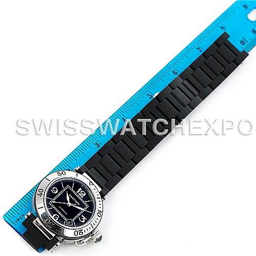 The image shows a Cartier Pasha W31077U2 Men
s Stainless Steel Black Dial W31077U2 Men
s Stainless Steel Black Dial watch laying flat with a black rubber strap placed alongside a blue ruler for measurement.