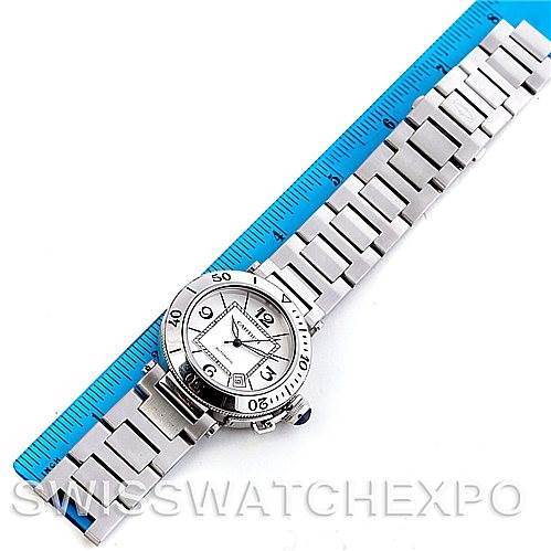 The image shows a top view of a Cartier Pasha W31080M7 Men
s Stainless Steel Silver Dial W31080M7 Men
s Stainless Steel Silver Dial model watch, including its face, bezel, and full metal strap, placed next to a blue ruler.