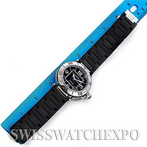 The image shows a top view of a Cartier Pasha W31077U2 Men
s Stainless Steel Black Dial W31077U2 Men
s Stainless Steel Black Dial watch with a black strap and a blue ruler for scale.