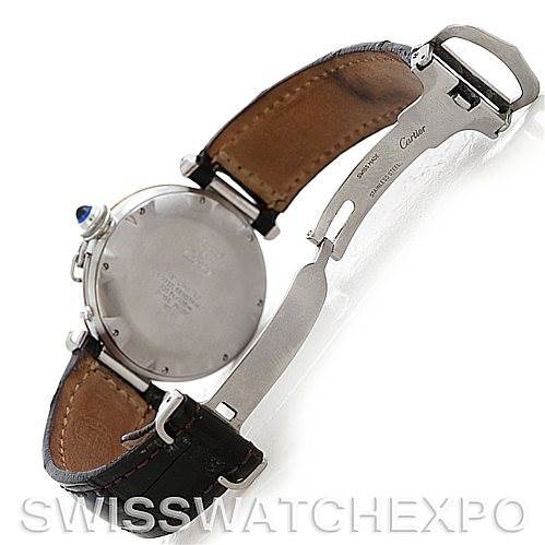 The image shows the back of a Pasha model by Cartier with its leather strap and deployment clasp partly open.
