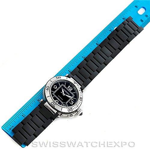 The Cartier Pasha W31077U2 Men
s Stainless Steel Black Dial W31077U2 Men
s Stainless Steel Black Dial model watch is shown from a top-down angle, measuring its length against a blue ruler.