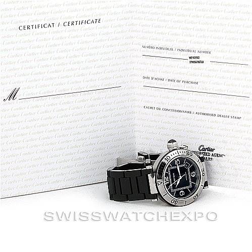 The image shows a Cartier Pasha W31077U2 Men
s Stainless Steel Black Dial W31077U2 Men
s Stainless Steel Black Dial watch lying on its side with its certificate documents in the background.