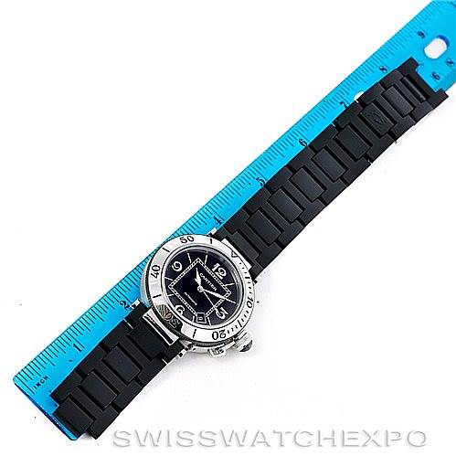 The image shows a top-down view of a Cartier Pasha W31077U2 Men's Stainless Steel Black Dial W31077U2 Men's Stainless Steel Black Dial watch placed alongside a blue ruler.