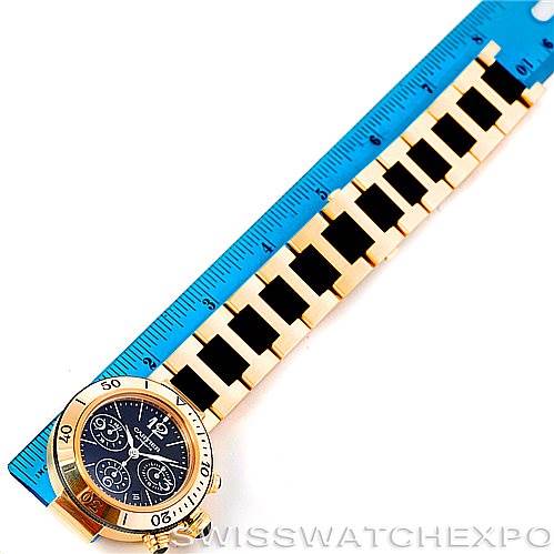 The image shows a Cartier Pasha W31088U2 Men's Yellow Gold Black Dial W31088U2 Men's Yellow Gold Black Dial watch face and band, aligned next to a blue ruler for scale, viewed from above.
