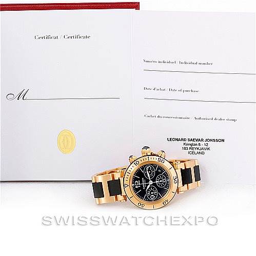 The image shows a Cartier Pasha W31088U2 Men's Yellow Gold Black Dial W31088U2 Men's Yellow Gold Black Dial watch with a certificate, displayed from an angle highlighting its face and band.