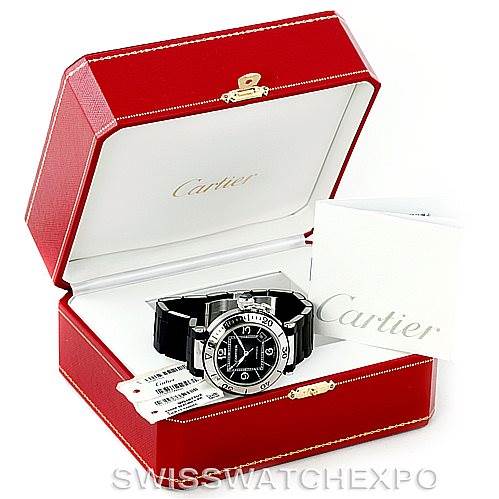 The watch is a Cartier Pasha W31077U2 Men's Stainless Steel Black Dial W31077U2 Men's Stainless Steel Black Dial model displayed in an open red Cartier box with a warranty card beside it.