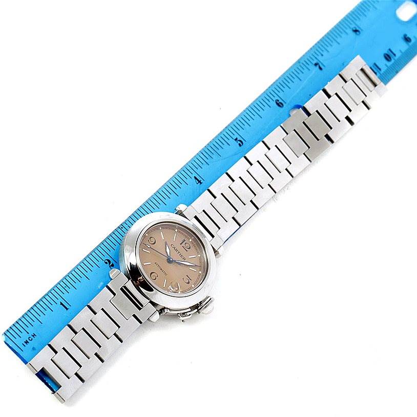 The Cartier Pasha W31023M7 Stainless Steel Pink Dial W31023M7 Stainless Steel Pink Dial watch is shown from a top view alongside a blue ruler for scale.