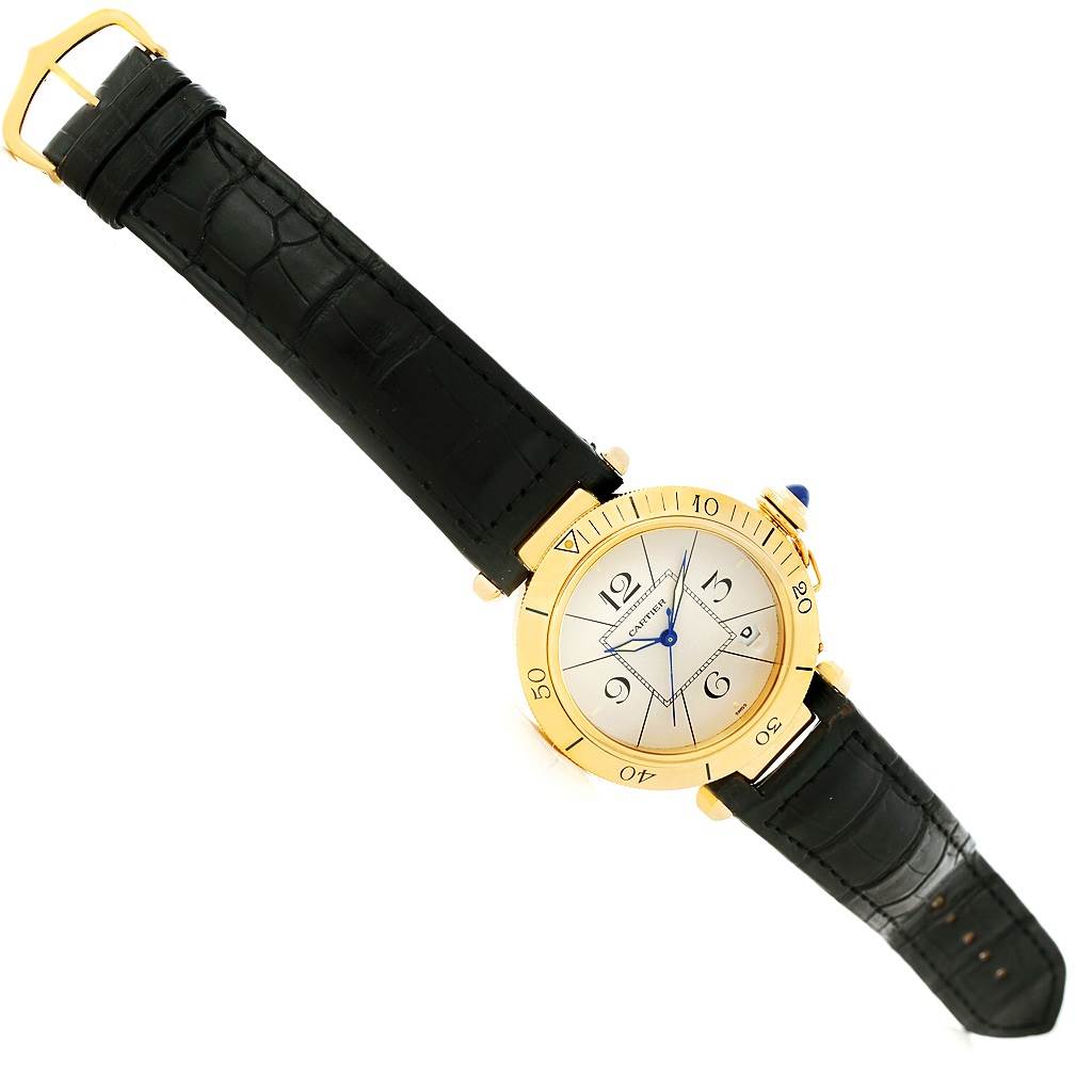The Cartier Pasha Men's Yellow Gold Silver Dial Men's Yellow Gold Silver Dial watch is shown from a top-down angle, displaying the entire face, bezel, and strap.