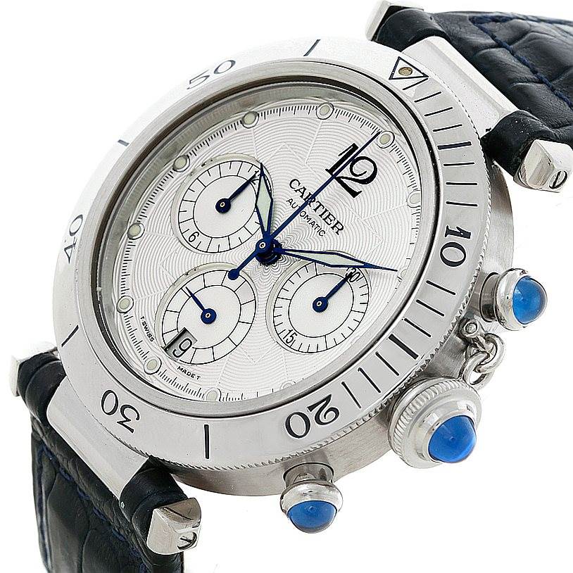 The image shows a close-up angle of the Cartier Pasha W3103055 Men's Stainless Steel Silver Dial W3103055 Men's Stainless Steel Silver Dial watch, highlighting its face, crown, subdials, and part of the leather strap.