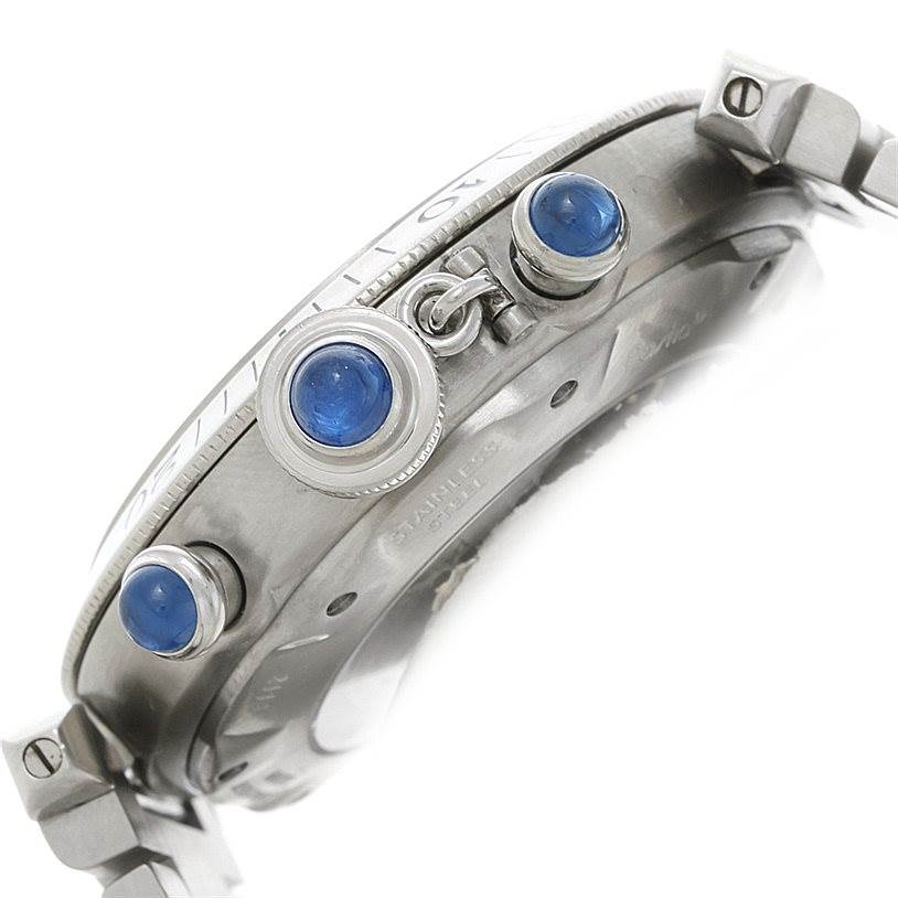 This image shows a side angle of the Cartier Pasha W31030H3 Men's Stainless Steel Silver Dial W31030H3 Men's Stainless Steel Silver Dial watch, highlighting its crown and pushers adorned with blue gems.