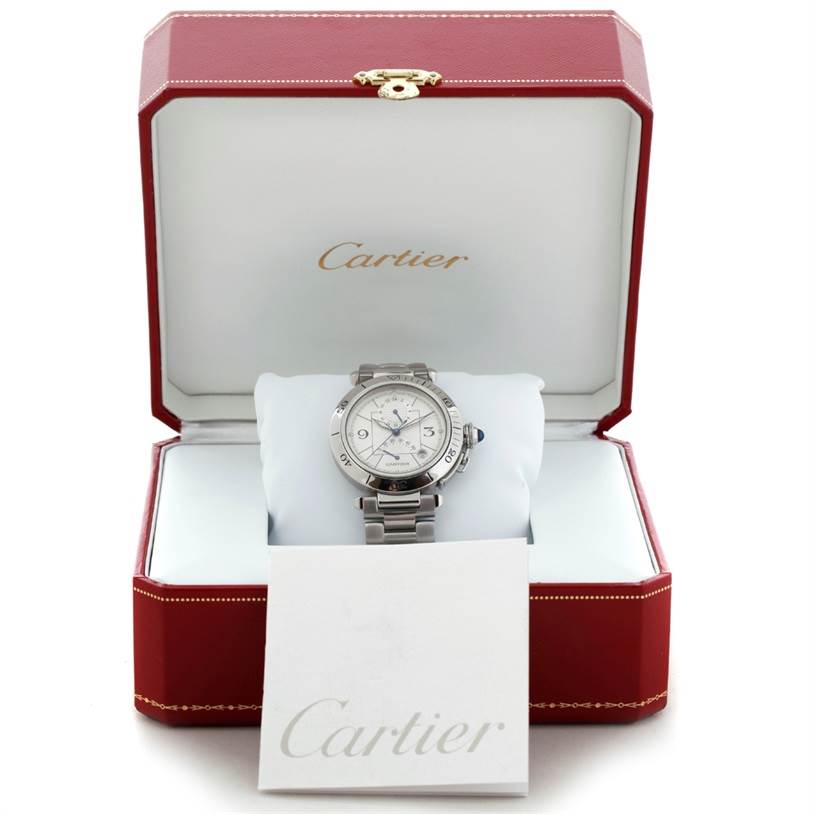 The Cartier Pasha W31037H3 Men
s Stainless Steel Silver Dial W31037H3 Men
s Stainless Steel Silver Dial watch is displayed head-on in an open red Cartier box, with a white cushion and an instruction booklet nearby.