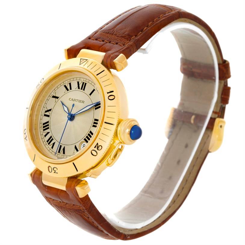 The image shows an angled view of a Cartier Pasha 10351 Men's Yellow Gold Silver Dial 10351 Men's Yellow Gold Silver Dial watch, highlighting its dial, bezel, crown, and leather strap.