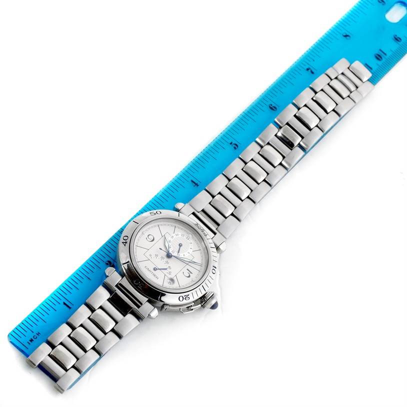 The photo shows a top-down view of the Cartier Pasha W31037H3 Men
s Stainless Steel Silver Dial W31037H3 Men
s Stainless Steel Silver Dial model watch, with its case and metal bracelet placed next to a ruler.