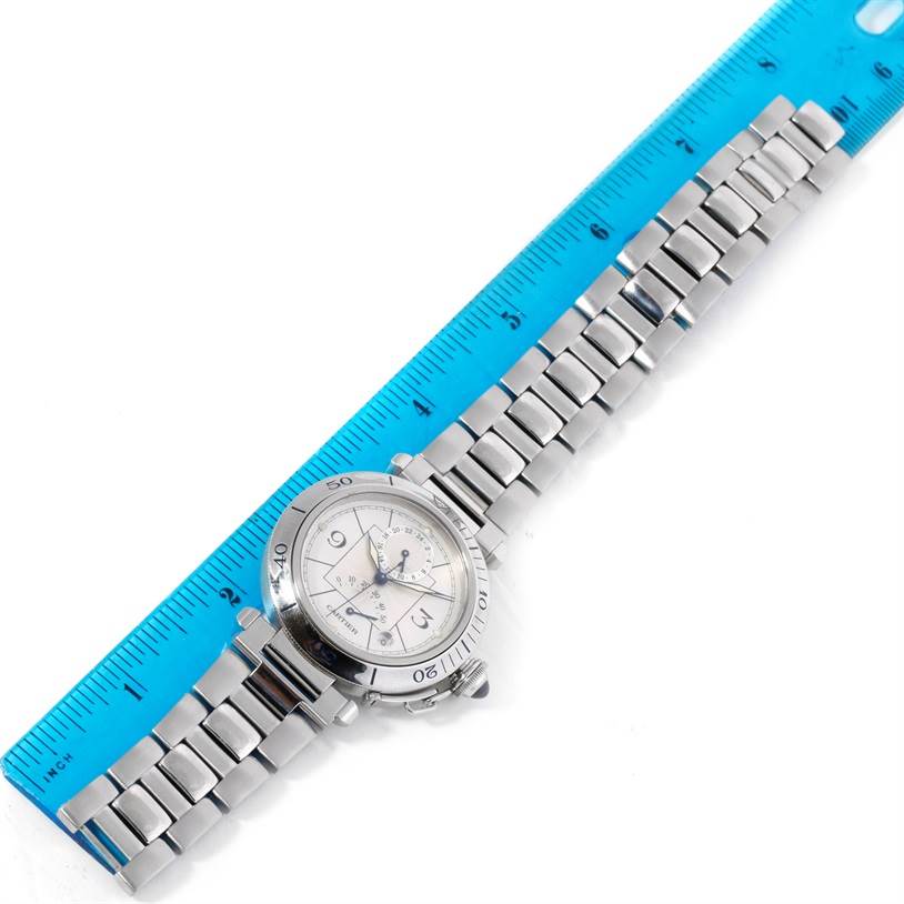 The image shows the entire Cartier Pasha W31037H3 Men
s Stainless Steel Silver Dial W31037H3 Men
s Stainless Steel Silver Dial watch laid flat, with its bracelet and face visible, next to a blue ruler.