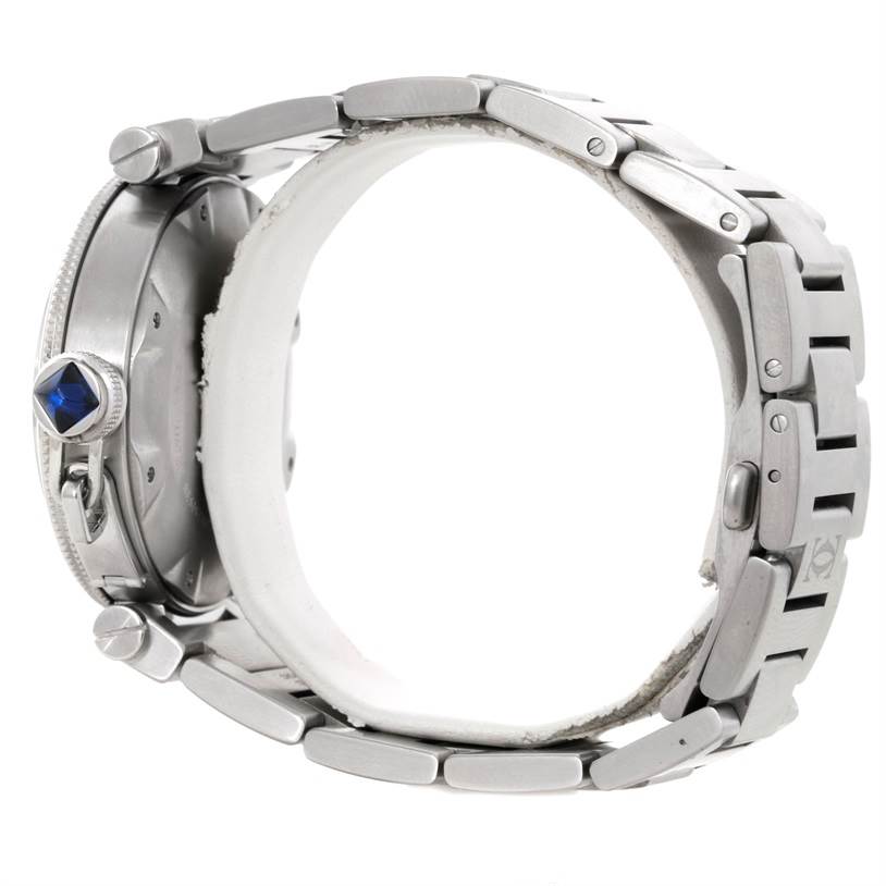 The image shows a side view of a Cartier Pasha W31080M7 Men
s Stainless Steel Silver Dial W31080M7 Men
s Stainless Steel Silver Dial watch, highlighting its sapphire-set crown and metal bracelet.