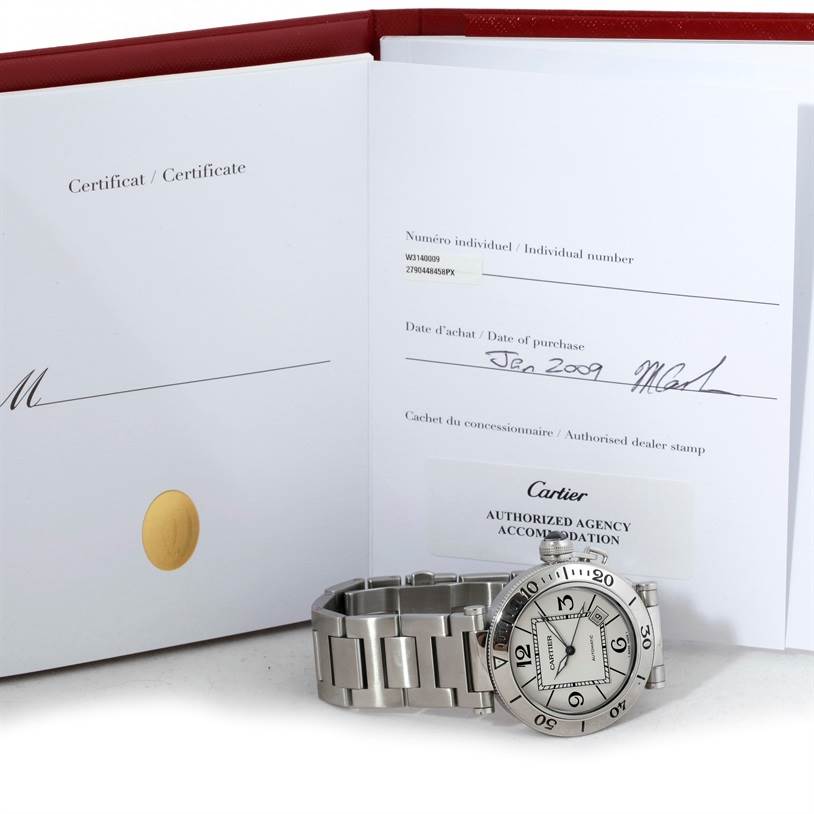 The image shows a Cartier Pasha W31080M7 Men
s Stainless Steel Silver Dial W31080M7 Men
s Stainless Steel Silver Dial model watch with its stainless steel bracelet, displayed alongside its certificate and red booklet.