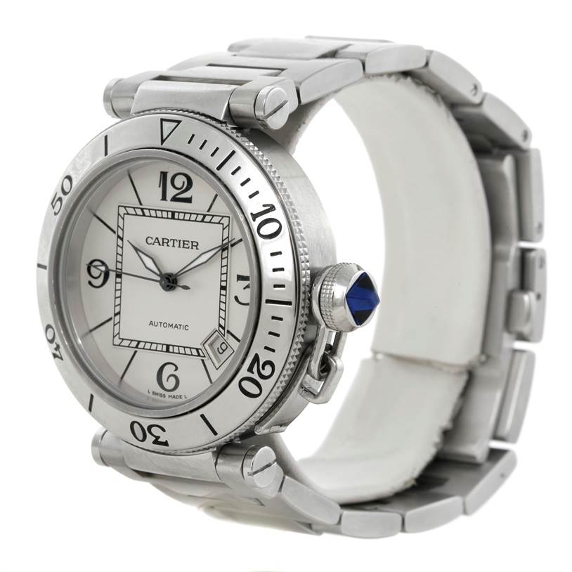 The image shows a Cartier Pasha W31080M7 Men
s Stainless Steel Silver Dial W31080M7 Men
s Stainless Steel Silver Dial watch angled to display its dial, bezel, crown with a blue gem, and metal bracelet.