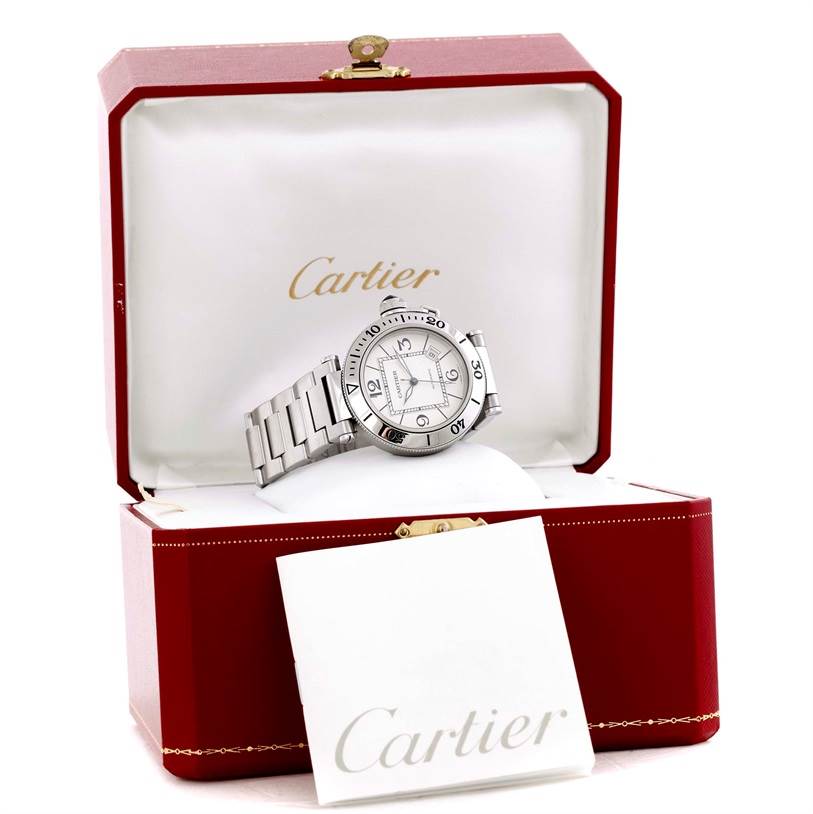 The image shows a Cartier Pasha W31080M7 Men's Stainless Steel Silver Dial W31080M7 Men's Stainless Steel Silver Dial watch in an open red Cartier case, with the watch displayed at a slight side angle.