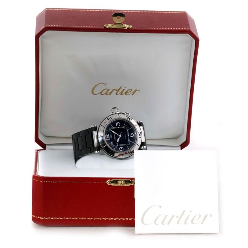 The Cartier Pasha W31077U2 Men
s Stainless Steel Black Dial W31077U2 Men
s Stainless Steel Black Dial watch is displayed at a frontal angle in its red and white box, accompanied by a Cartier-branded card.