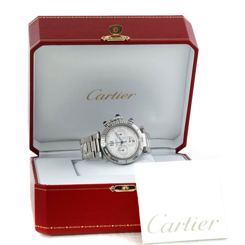 The Cartier Pasha W31030H3 Men
s Stainless Steel Silver Dial W31030H3 Men
s Stainless Steel Silver Dial watch is displayed inside a red Cartier box with a white card in front.