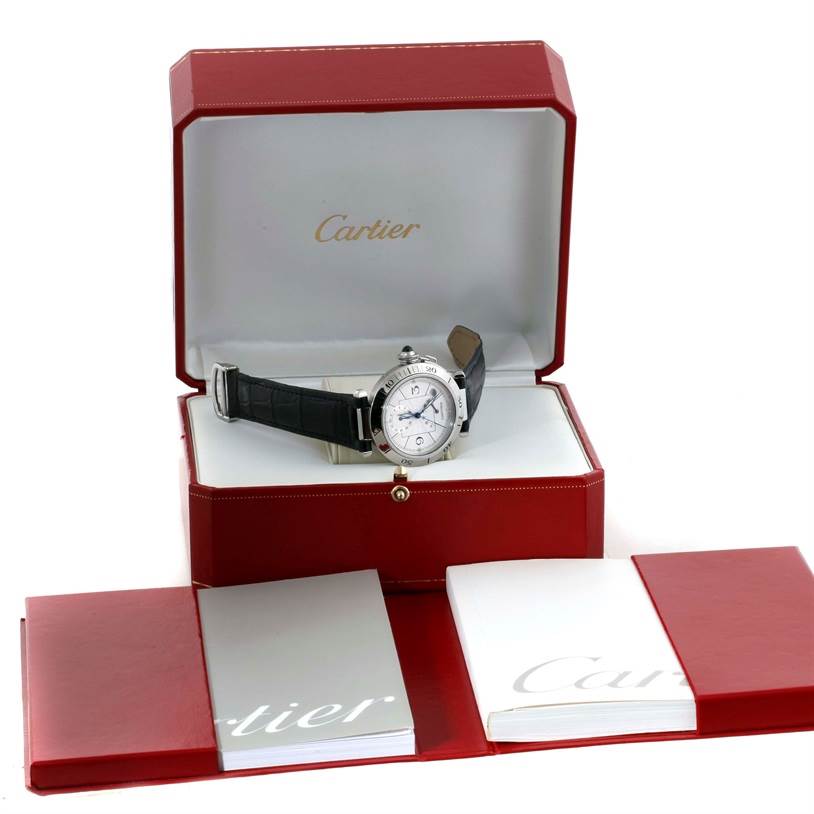 The Cartier Pasha W31037H3 Men
s Stainless Steel Silver Dial W31037H3 Men
s Stainless Steel Silver Dial watch is displayed at an angled front view inside its red box, accompanied by booklets.